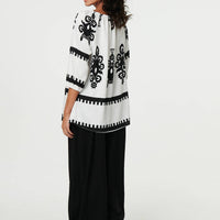 Ikat Print Tassel Tie Neck Blouse